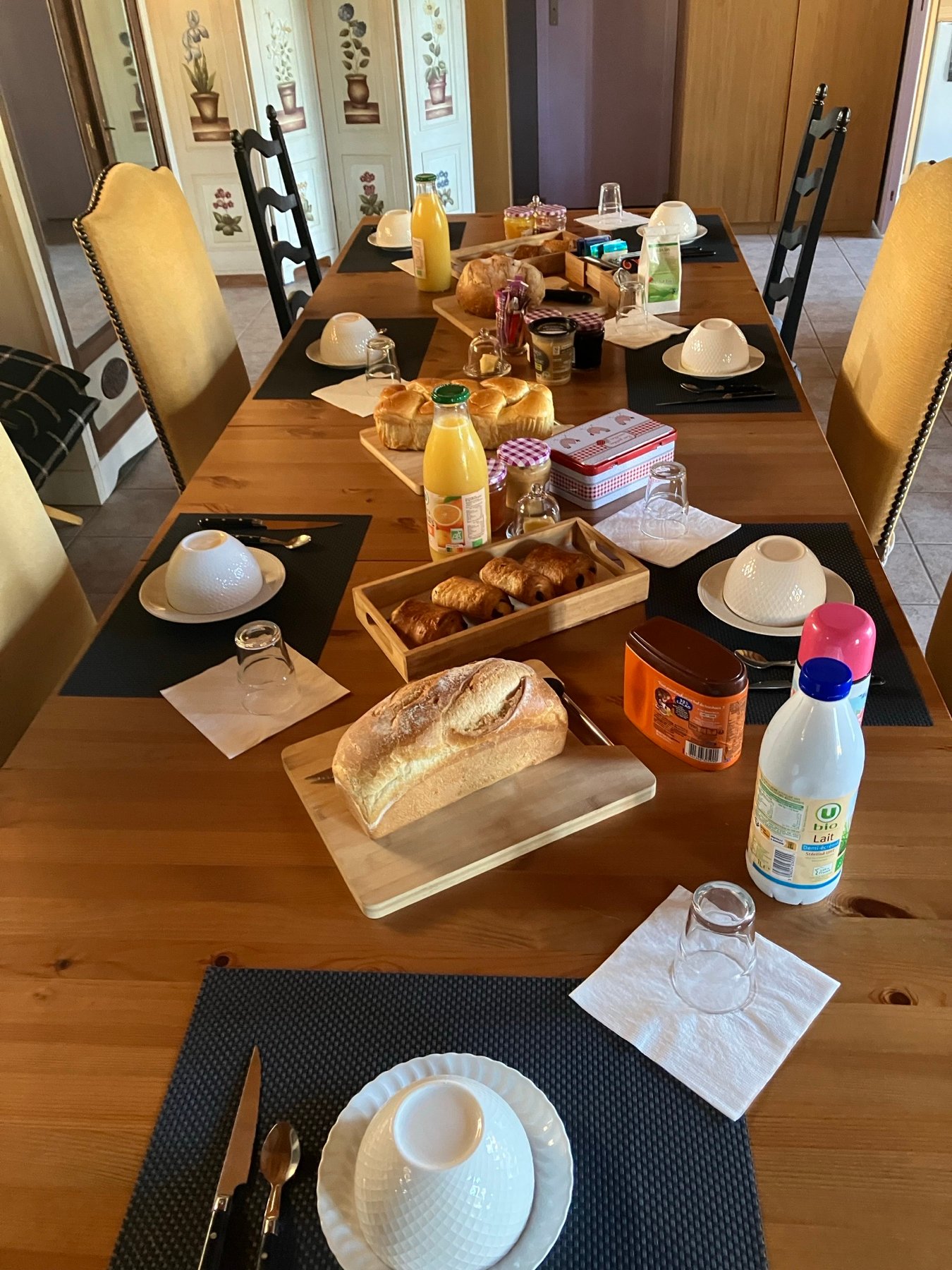Homemade breakfast — set table with bread, pastries, orange juice